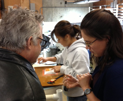 Bodega Marine Laboratory postdoctoral researcher Kristin Aquilino shows a baby white abalone to Joe Palca
