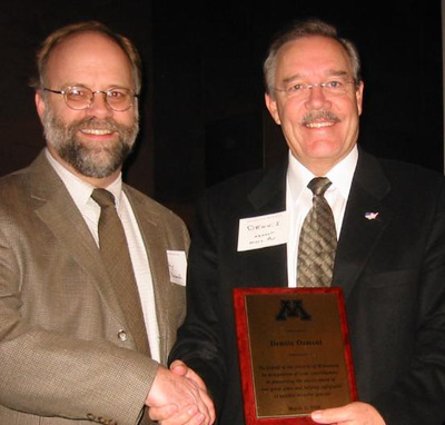 University of Minnesota Vice President for Research, Tim Mulcahy, awards MN Representative, Dennis Ozment, for his long record of support for research on invasive species