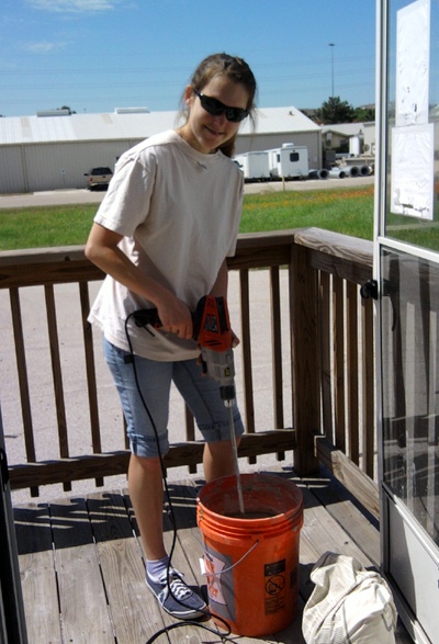 IGERT trainee Erin Darling is mixing a batch of clay-based paint for full-scale testing in an NSF-funded test house (UTest House)